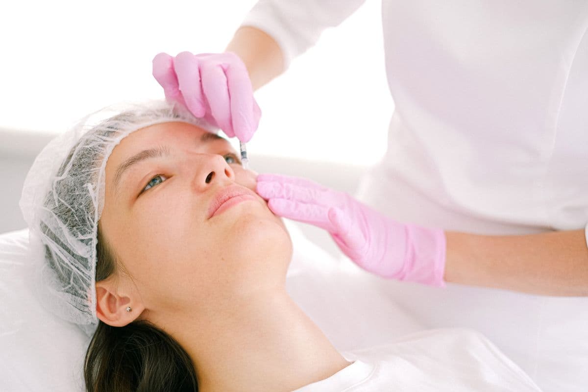 A person receiving a cosmetic facial injection at a med spa