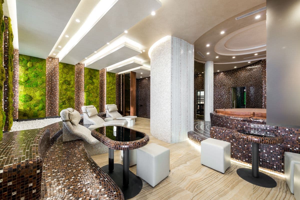 A bright, modern Neon spa interior with greenery